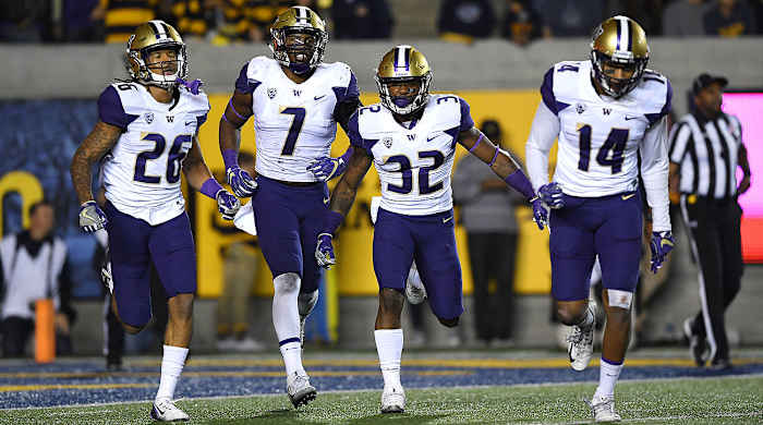 Budda Baker (No. 32) with Washington teammates Sidney Jones (26), Keishawn Bierria (7) and Jojo McIntosh (14).